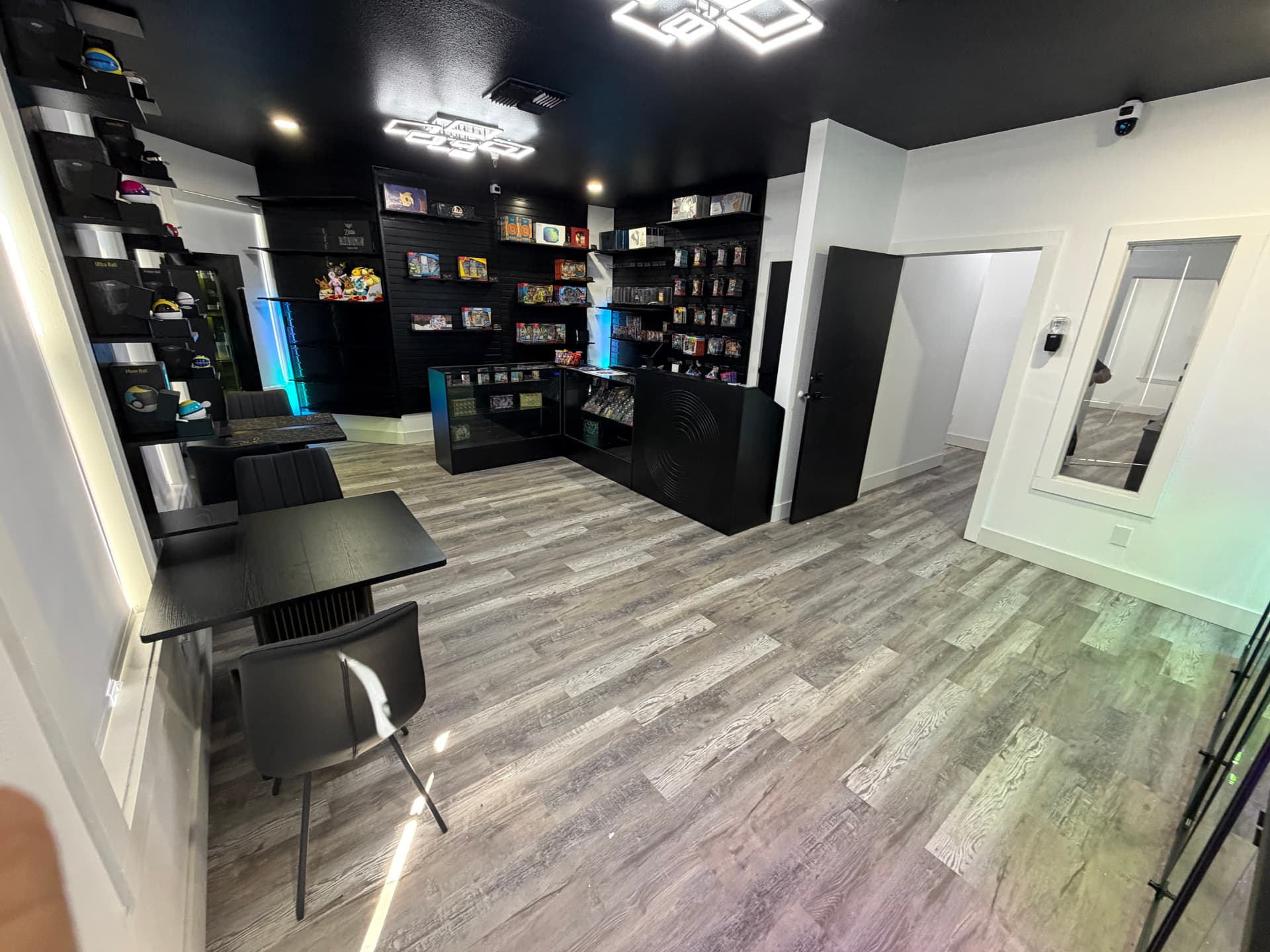 Inside Kam's Korner: black shelving walls stocked with sealed product